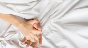 Couple Holding Hands in Bed